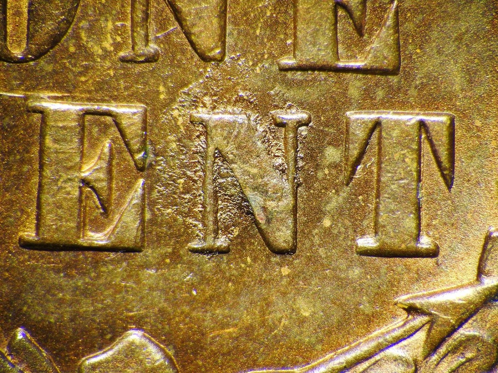 1876 Indian Head penny Variety 4 die rust texture on Liberty's second feather and lint hub-through marks in denticles near 9:30 position